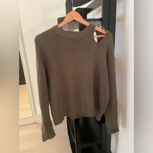Green sweater with cut-out